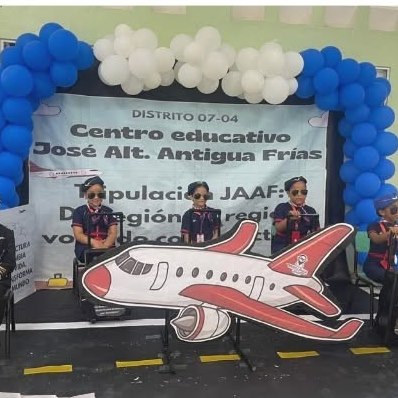 Students on stage under a balloon arch after winning their regional reading competition
